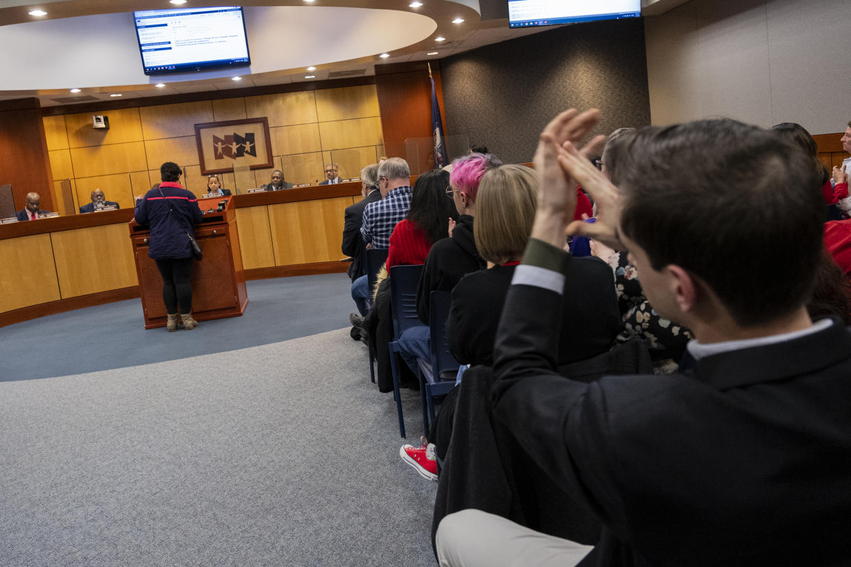 Community members clap in support of Evelyn Cox as she speaks about poor behavior from students in front of the Newport News School Board at the Newport News Public Schools Administration building on Tuesday, Jan. 17, 2023, in Newport News, Va. Community members spoke about issues and solutions to violence in schools following the shooting at Richneck Elementary by a six-year-old that left a teacher in critical condition. (Billy Schuerman/The Virginian-Pilot via AP)