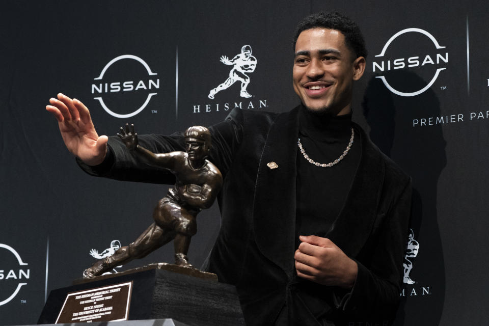 Alabama quarterback Bryce Young poses for a photograph after winning the Heisman Trophy, Saturday, Dec. 11, 2021, in New York. (AP Photo/John Minchillo)