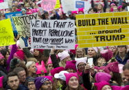 <p>Women with bright pink hats and signs begin to gather early to make their voices heard on the first full day of Donald Trump’s presidency, Saturday, Jan. 21, 2017, in Washington. (AP Photo/Jose Luis Magana) </p>