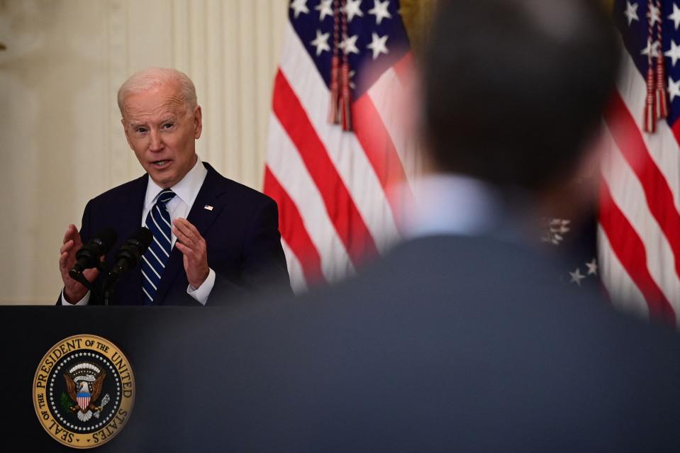 President Joe Biden answers a question during his first press briefing as president in the East Room of the White House.