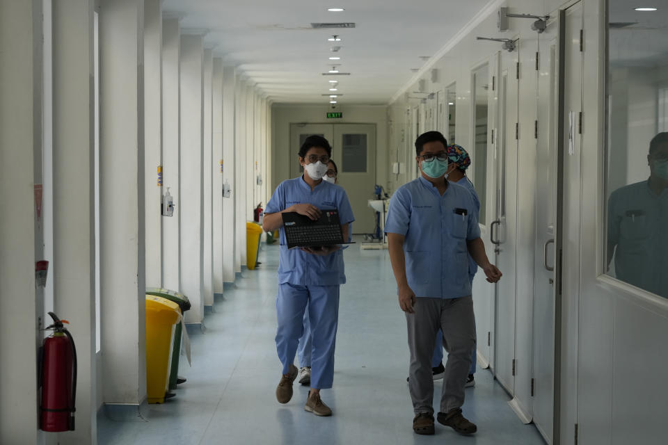 A doctor and nurses prepare to visit patients at Persahabatan Hospital, a national respiratory referral hospital, in Jakarta, Indonesia, on Sept. 22, 2023. Pollution is causing respiratory illnesses and deaths to rise in Indonesia's island of Java, including the capital, Jakarta. Data gathered by IQAir, a Swiss air technology company, regularly ranks Jakarta as one of the most polluted cities in the world. Blue skies are a rare sight and the air often smells like fuel or heavy smoke. (AP Photo/Achmad Ibrahim)