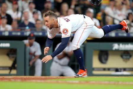 Jul 14, 2018; Houston, TX, USA; Houston Astros center fielder George Springer (4) dives towards home plate looking to score a run against the Detroit Tigers during the second inning at Minute Maid Park. Mandatory Credit: Erik Williams-USA TODAY Sports