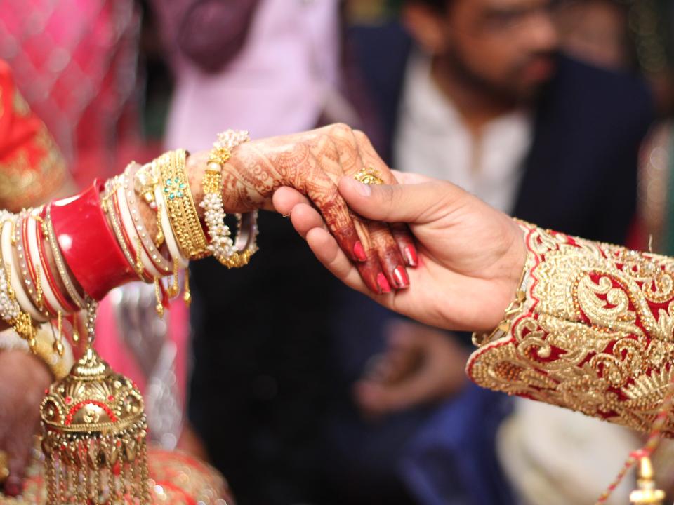 Newlywed Couple Holding Hands In Wedding Ceremony in India