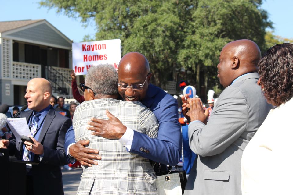 Sen. Raphael Warnock shares a hug with a supporter during a street renaming celebration near his childhood home in Savannah.