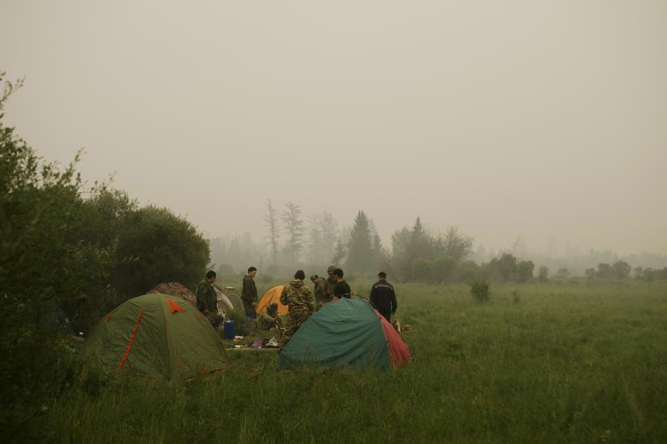 Member of volunteers crew rest at their tent camp at Gorny Ulus area west of Yakutsk, Russia, Tuesday, July 20, 2021. The hardest hit area is the Sakha Republic, also known as Yakutia, in the far northeast of Russia, about 5,000 kilometers (3,200 miles) from Moscow. Volunteers have joined over 5,000 regular firefighters in the effort, motivated by their love of the vast region. (AP Photo/Ivan Nikiforov)