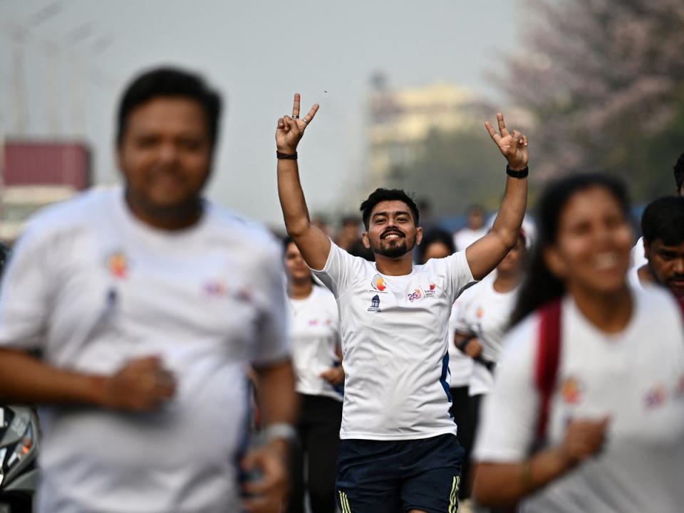 Participants walk down a road during the Vote-A-Thon, an awareness campaign organised by the Karnataka’s Chief Electoral Office to encourage 100 per cent voting turnout for the upcoming 2024 general elections, in Bengaluru on 17 March 2024 (AFP via Getty Images)