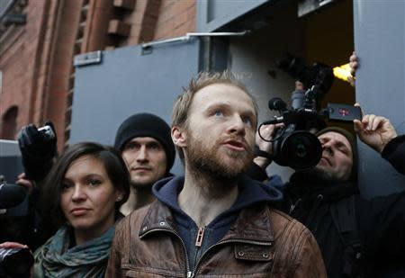 Photographer Denis Sinyakov of Russia accompanied by his wife Alina speaks to the media after being released from prison in St. Petersburg November 21, 2013. REUTERS/Alexander Demianchuk