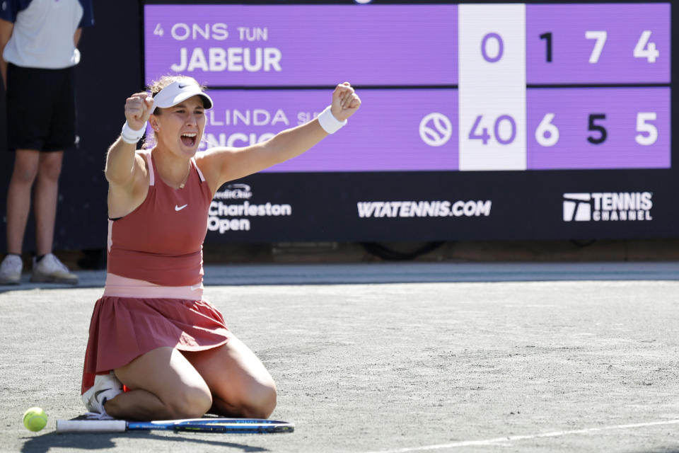 Belinda Bencic, of Switzerland, celebrates after defeating Ons Jabeur, of Tunisia, in the the finals at the Charleston Open tennis tournament in Charleston, S.C., Sunday, April 10, 2022. (AP Photo/Mic Smith)