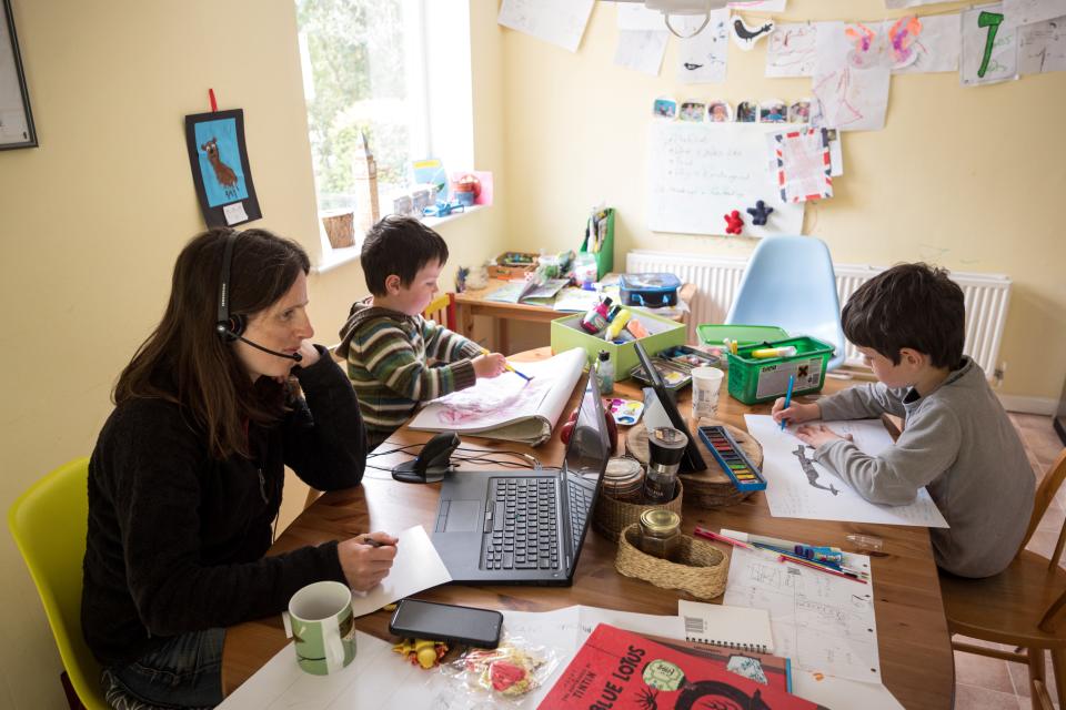 Six-year-old Leo (R) and his three-year old brother Espen (C) complete homeschooling activities suggested by the online learning website of their infant school, as his mother Moira, an employee of a regional council, works from home in the village of Marsden, near Huddersfield, northern England on May 15, 2020, during the novel coronavirus COVID-19 pandemic.  Leo (R), aged 6, and Espen, aged 3, undertake homeschool activities suggested by the online learning website of their infant school whilst their mother Moira, a council employee, works from home in the village of Marsden, near Huddersfield, northern England on May 15, 2020. - Prime Minister Boris Johnson has urged millions unable to work from home to return to their jobs under the new guidelines, which do not apply in Scotland, Wales or Northern Ireland. (Photo by OLI SCARFF / AFP) (Photo by OLI SCARFF/AFP via Getty Images)