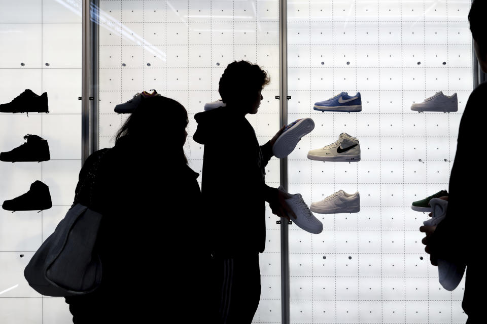 FILE - People shop for shoes in a Nike store on Black Friday, Nov. 25, 2022, in New York. On Tuesday, Dec. 13, the Labor Department reports on U.S. consumer prices for November. (AP Photo/Julia Nikhinson, File)