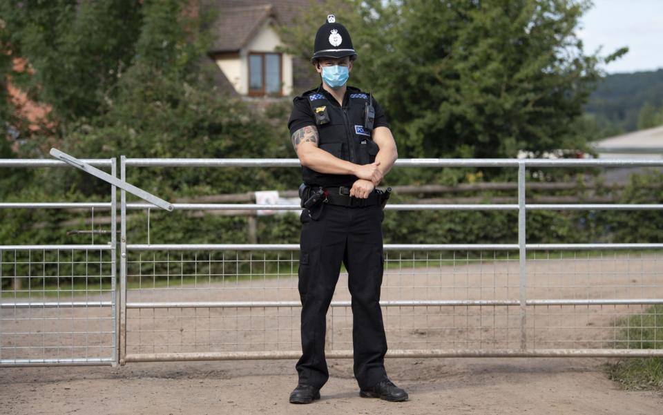 A police officer stands at the entrance to the AS Green & Co farm - Matthew Horwood/Getty