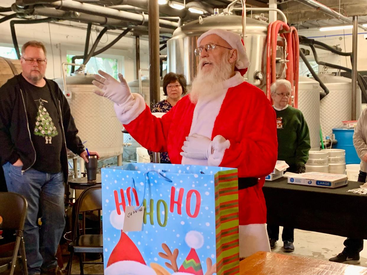 Santa Claus (Ray Turner) thanks volunteers and helpers during the Kings' Daughters' School's annual Christmas celebration at Asgard Brewing Co. & Taproom on Tuesday, Dec. 21, 2021.