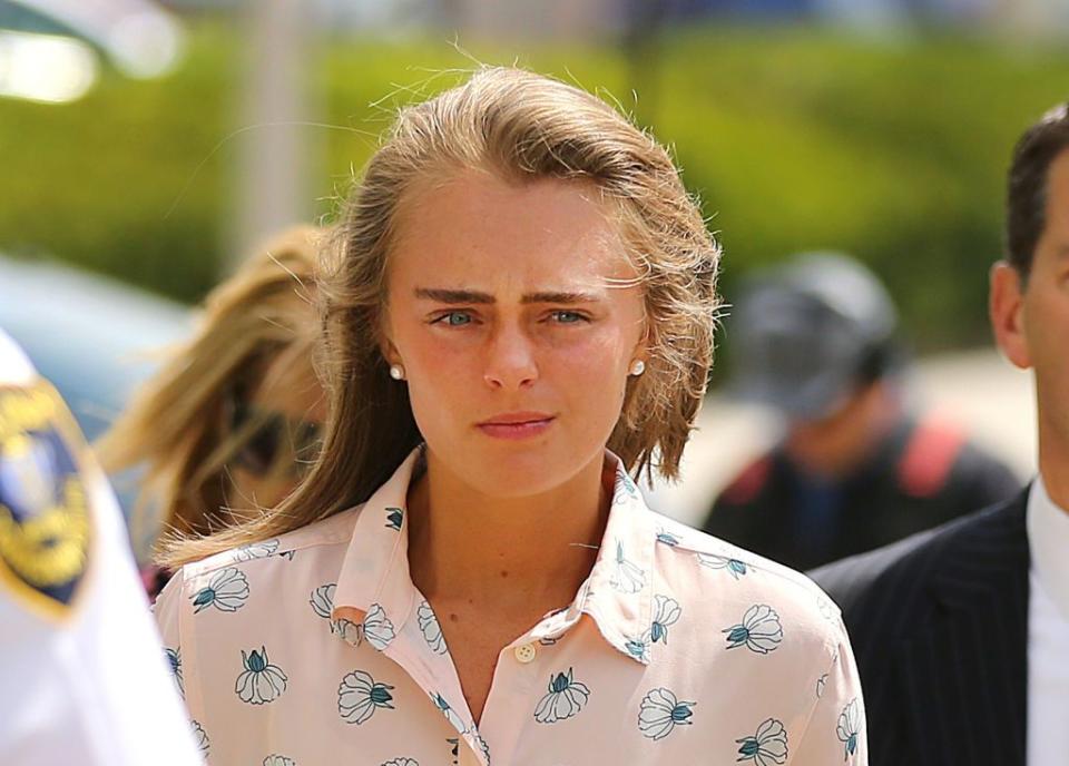 michelle carter, a blonde woman with straight brown eyebrows and wearing a pink shirt, arrives to hear the verdict of her trial, she was later charged with involuntary manslaughter for encouraging 18 year old conrad roy to kill himself