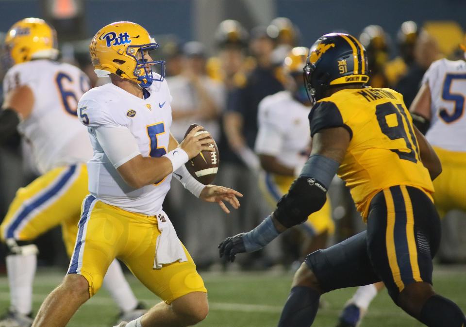 Pittsburgh Panthers Phil Jurkovec (5) attempts to evade West Virginia Mountaineers Sean Martin (91) while looking downfield for an open receiver during the first half at Milan Puskar Stadium in Morgantown, WV on September 16, 2023.