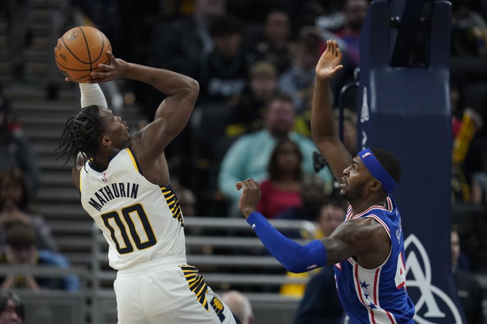 Indiana Pacers' Bennedict Mathurin (00) shoots against Philadelphia 76ers' Paul Reed (44) during the first half of an NBA basketball game Thursday, Jan. 25, 2024, in Indianapolis. (AP Photo/Darron Cummings)