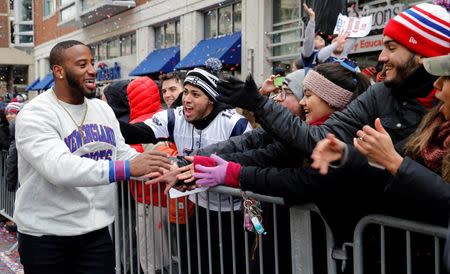 Feb 4, 2015; Boston, MA, USA; New England Patriots running back James White (28) celebrates with some fans during the Super Bowl XLIX-New England Patriots Parade. Mandatory Credit: Greg M. Cooper-USA TODAY Sports