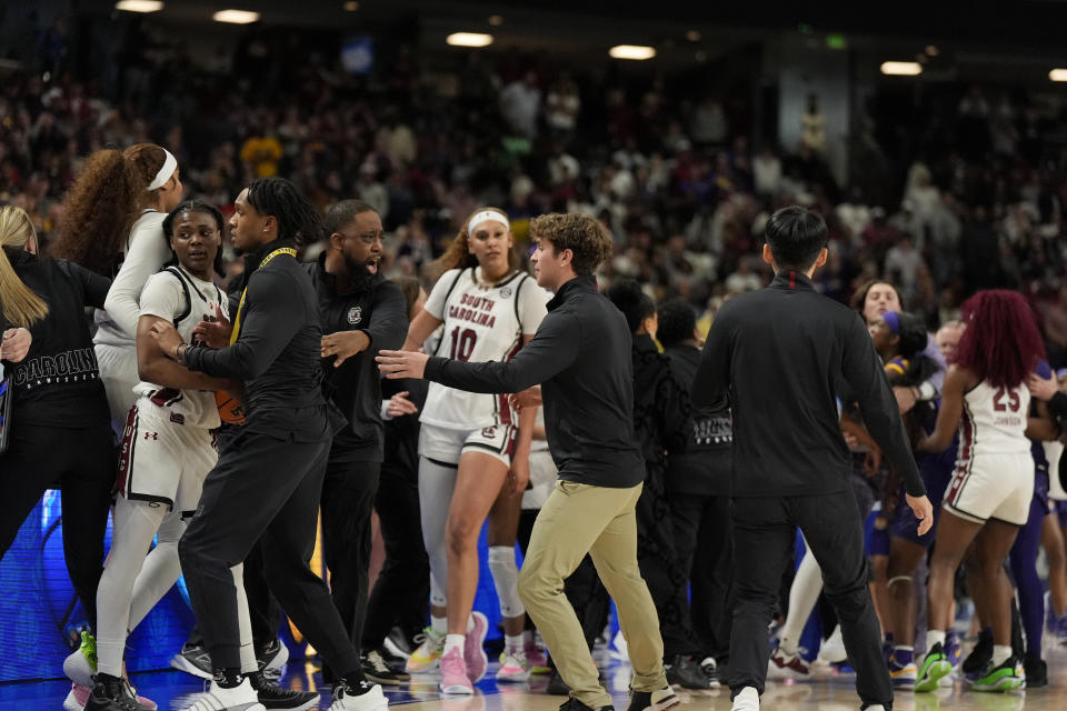 The benches clear during a player altercation during the second half of an NCAA college basketball game against LSU at the Southeastern Conference women's tournament final Sunday, March 10, 2024, in Greenville, S.C. (AP Photo/Chris Carlson)