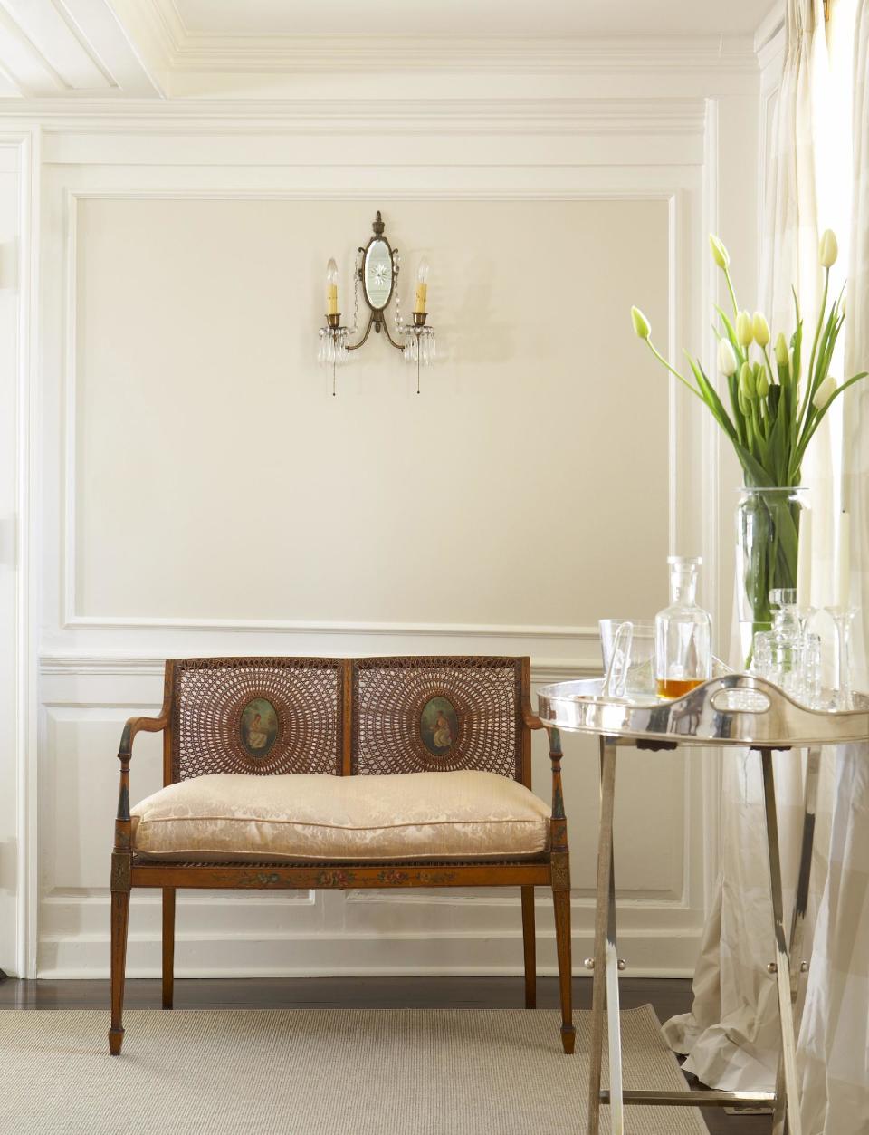 This undated image provided by Benjamin Moore shows a room painted with several different shades of white, with a warmer white on the wall inset to punctuate the classic trim detail and add to the formal feel of the space. Consumers often say they want to use white paint in order to avoid strong colors, but there are dozens of whites available, making it a challenging color to use. (AP Photo/Benjamin Moore, Michael Partenio)