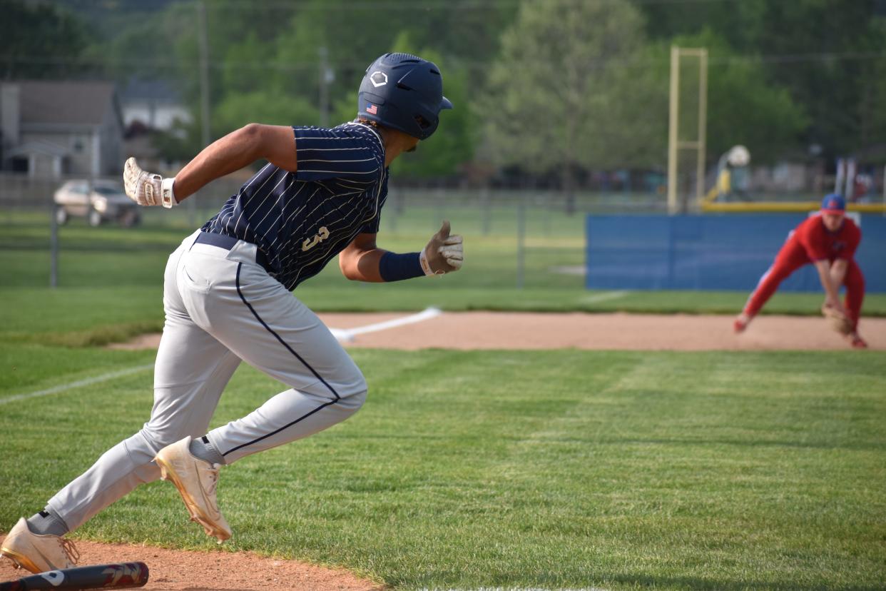 Decatur Central's Keelan Dyson makes a dash for first base after batting a grounder towards Martinsville third baseman Ian Nuckles, who picks up the ball, during their matchup on May 10, 2022.