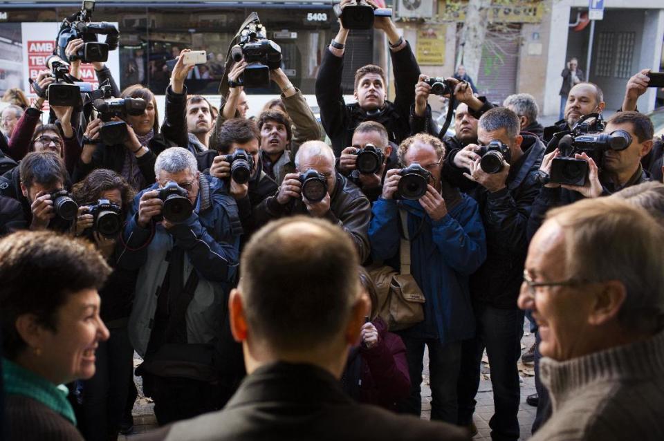 Press photographers take photos as the owners of a lottery office celebrate after selling the first Christmas lottery prize “El Gordo” (“The Fat One”) in Barcelona, Spain, Sunday Dec. 22, 2013. Millions of Spaniards are glued to televisions as the country's cherished Christmas lottery, the world's richest, distributes a bounty of 2.5 billion euros ($3.4 billion) in prize money to winning ticket owners. The draw is so popular that most of Spain's 46 million inhabitants traditionally watch some part of it live in the hope that the school children singing out winning numbers will call out their ticket. The top prize, known as "El Gordo" (The Fat One), gives lucky winners 400,000 euros per ticket Sunday, while the second-best number nets 125,000 euros. (AP Photo/Emilio Morenatti)