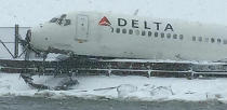 A Delta jet which skidded off the runway at Laguardia airport is seen jutting above a dyke in New York City March 5, 2015, in a photo provided by the New York Police Department. A Delta Air Lines jetliner with 125 passengers and five crew members aboard slid off the runway upon landing during a snowstorm at New York's LaGuardia Airport on Thursday, but officials said there were no serious injuries. REUTERS/New York Police Department/handout via Reuters (UNITED STATES - Tags: DISASTER TRANSPORT ENVIRONMENT) NO SALES. NO ARCHIVES. FOR EDITORIAL USE ONLY. NOT FOR SALE FOR MARKETING OR ADVERTISING CAMPAIGNS. THIS IMAGE HAS BEEN SUPPLIED BY A THIRD PARTY. IT IS DISTRIBUTED, EXACTLY AS RECEIVED BY REUTERS, AS A SERVICE TO CLIENTS