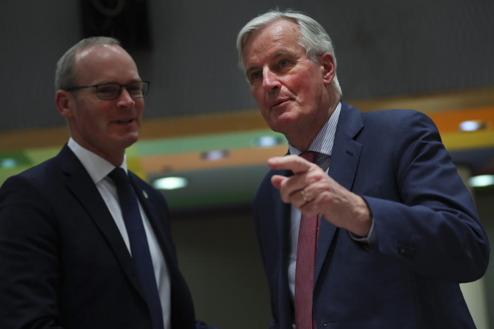 European Union Brexit negotiator Michel Barnier, right, talks to Irish Foreign Minister Simon Coveney during a meeting of EU ministers for European Affairs at the EU Council building in Brussels, Tuesday, March 19, 2019. The British government was preparing Tuesday to ask the European Union for a delay of at least several months to Brexit after the speaker of the House of Commons ruled that Prime Minister Theresa May cannot keep asking lawmakers to vote on the same divorce deal that they have already rejected twice. (AP Photo/Francisco Seco)