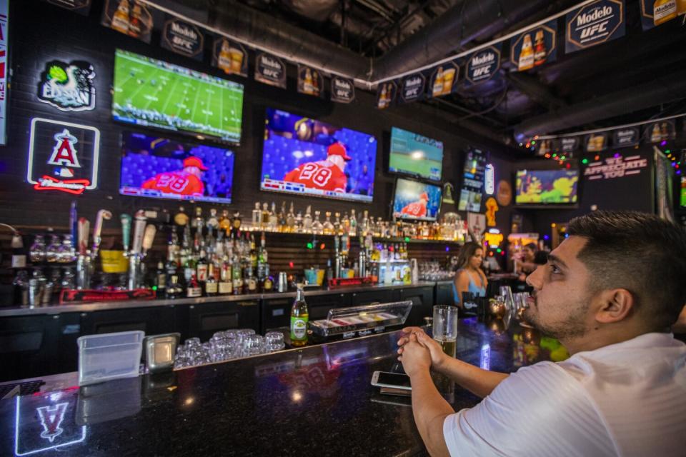 Angels fan Edgar Rodriguez watches a game at Lopez & Lefty's in Anaheim.