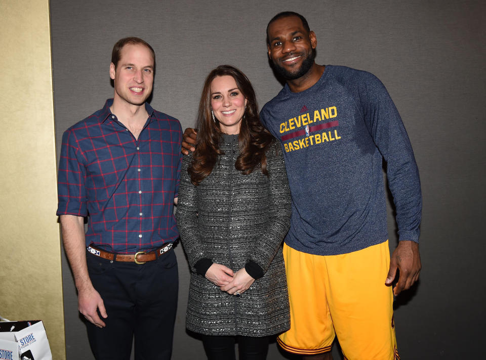 Prince William and Catherine, Duchess of Cambridge pose with LeBron James as they attend a Cleveland Cavaliers vs. Brooklyn Nets game on Dec. 8, 2014. (Pool via Getty Images)