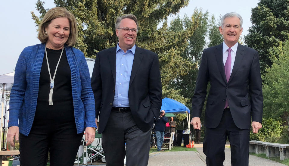 Federal Reserve Chairman Jerome Powell (R) speaks with New York Fed President John Williams and Kansas City Fed President Esther George (L) at the Kansas City Fed’s annual Economic Symposium in Jackson Hole, Wyoming, U.S. August 24, 2018. REUTERS/Ann Saphir