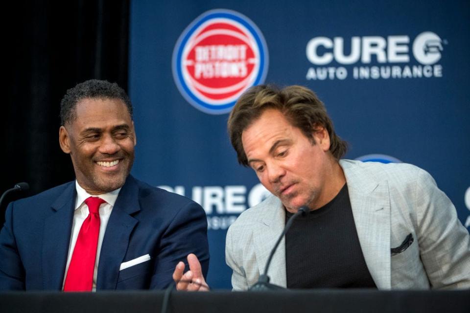 From left, Detroit Pistons general manager Troy Weaver laughs while listening to owner Tom Gores during a news conference introducing the team's draft class July 30, 2021 at the Pistons Performance Center in Detroit.