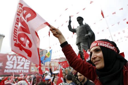 A supporter of Turkish President Tayyip Erdogan waves a "Yes" campaign flag during a rally for the upcoming referendum in the Black Sea city of Rize, Turkey, April 3, 2017. REUTERS/Umit Bektas