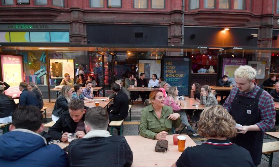 As bars reopened on Saturday, the Northern Quarter set out tables for customers on the closed road.