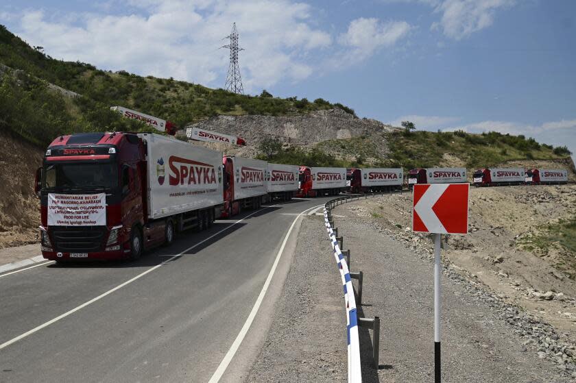 FILE - Trucks with humanitarian aid for Artsakh parked in a road towards the separatist region of Nagorno-Karabakh, in Armenia, on July 28, 2023. Armenia called on the U.N. Security Council to hold an emergency meeting on the worsening humanitarian situation in Azerbaijan's Nagorno-Karabakh region, which is mostly populated by Armenians. In his letter to the president of the U.N. Security Council, sent Friday and released by Armenia's Foreign Ministry on Saturday Aug. 12, 2023, Armenian U.N. ambassador Mher Margaryan said the people of Nagorno-Karabakh were "on the verge of a full-fledged humanitarian catastrophe." (Hayk Manukyan/PHOTOLURE via AP, File)