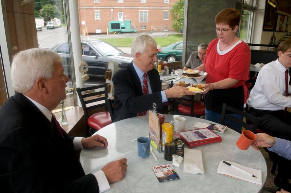 Jeannie McDaniel, right, a waitress at Long's Drug Store brings breakfast plates for Shelby County district attorney and Republican candidate for governor Bill Gibbons, center, and Knox County District Attorney General Randy Nichols, left, on July 23, 2009. Long's has been a gathering place for politicians and candidates for decades.