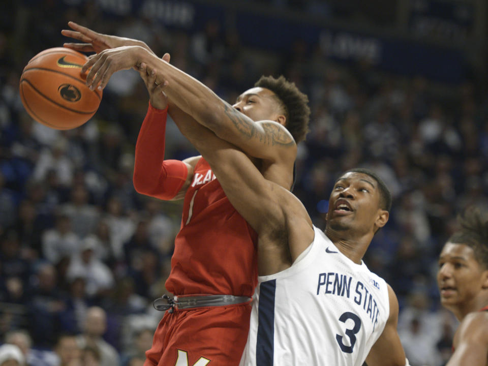 Maryland's Jahmir Young,left, and Penn State's Kebba Njie (3) battle for a rebound during the first half of an NCAA college basketball game, Sunday, March 5, 2023, in State College, Pa. (AP Photo/Gary M. Baranec)