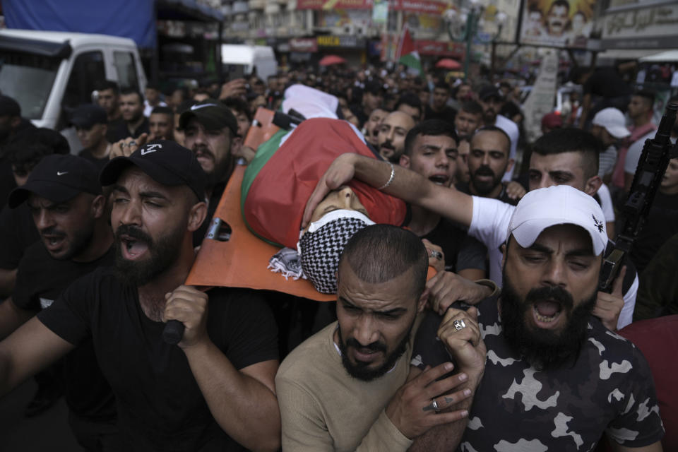 Palestinian mourners carry the body of Khalil Yahya Anis during his funeral in the West Bank city of Nablus, Thursday, June 15, 2023. The Palestinian Health Ministry said the 20-year-old man was shot in the head by Israeli forces. The Israeli military said troops operating in the city came under fire and fired back. (AP Photo/Nasser Nasser)