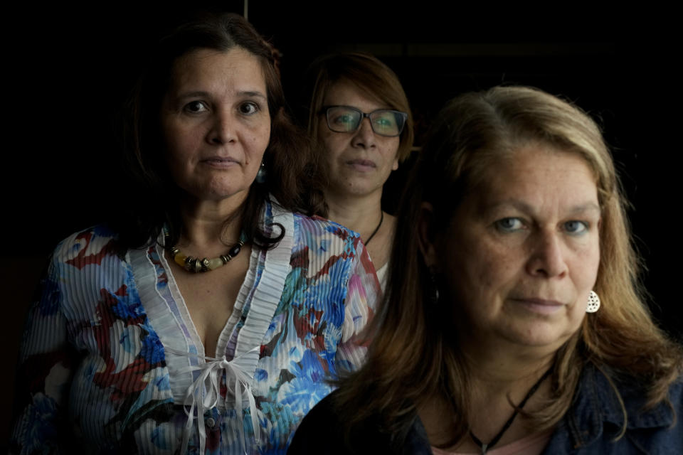 Lucia Gimenez, from left, Alicia Torancio, and Beatriz Delgado, former Opus Dei domestic workers, pose for a photo in Buenos Aires, Argentina, Thursday, Oct. 21, 2021. The women have filed a complaint against Opus Dei to the Vatican for alleged labor exploitation, and abuses of power and of conscience. (AP Photo/Natacha Pisarenko)