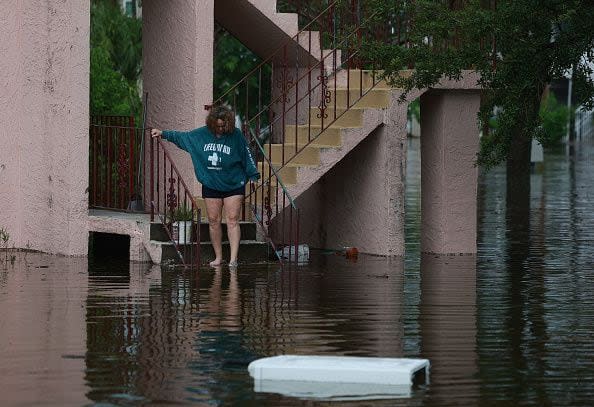 TARPON SPRINGS, FLORIDA - AUGUST 30: Tina Kruse looks out at the flood waters from Hurricane Idalia surrounding her apartment complex on August 30, 2023 in Tarpon Springs, Florida. Hurricane Idalia is hitting the Big Bend area of Florida.  (Photo by Joe Raedle/Getty Images)