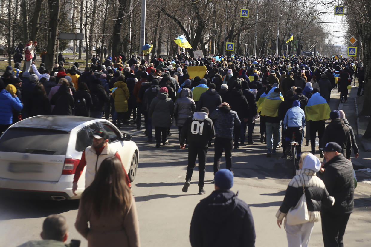 FILE - People walk in a street during a rally against Russian occupation in Kherson, Ukraine, on March 13, 2022. According to Russian state TV, the future of the Ukrainian regions occupied by Moscow's forces is all but decided: Referendums on becoming part of Russia will soon take place there, and the joyful residents who were abandoned by Kyiv will be able to prosper in peace. In reality, the Kremlin appears to be in no rush to seal the deal on Ukraine's southern regions of Kherson and Zaporizhzhia and the eastern provinces of Donetsk and Luhansk. (AP Photo/Petros Giannakouris)