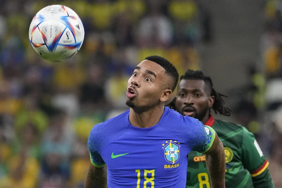 Brazil's Gabriel Jesus, front, and Cameroon's Andre-Frank Zambo Anguissa fight for he ball during the World Cup group G soccer match between Cameroon and Brazil, at the Lusail Stadium in Lusail, Qatar, Friday, Dec. 2, 2022. (AP Photo/Moises Castillo)