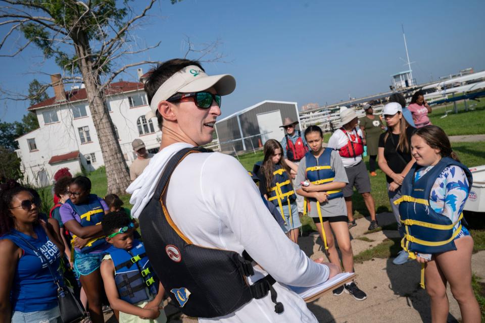 Grace Pytell, 29, of Grosse Pointe Farms, director of the Detroit Community Sailing Center, instructs new students who are participating in the Challenge the Wind program on Monday, July 24, 2023, from the banks of the Belle Isle Boat House. Challenge the Wind was started by the Detroit Community Sailing Center, which teaches youths ages 10-17 how to sail. The emphasis is on water safety and STEM to help increase access to Detroit's waterways for youths who would otherwise not get the opportunity.