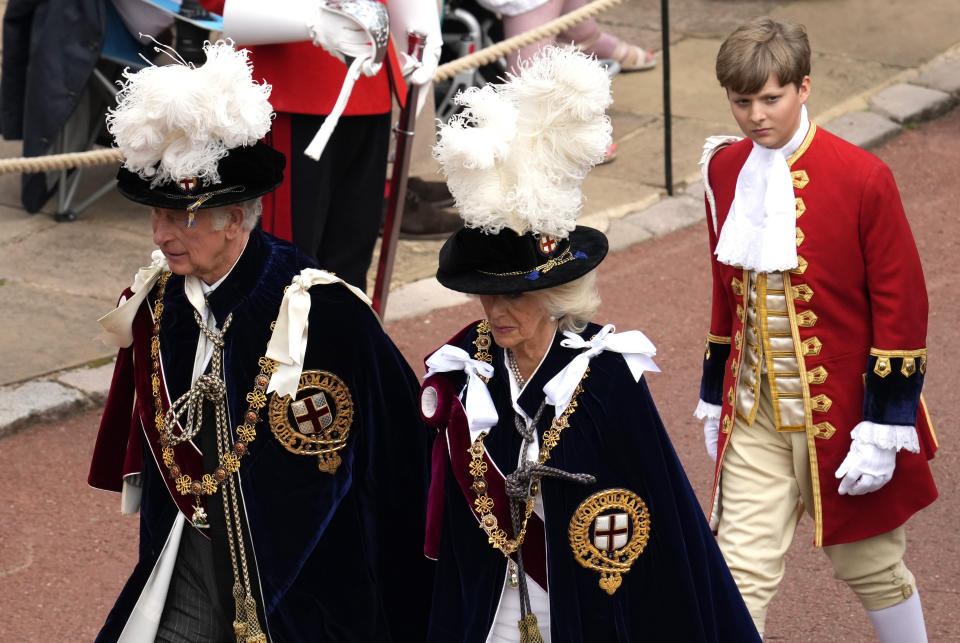 Britain's Prince Charles, Prince of Wales, left, and Camilla, Duchess of Cornwall, center, walk in the procession to St George's Chapel for the Order of the Garter service at Windsor Castle, in Windsor, England, Monday, June 13, 2022. The Order of the Garter is the oldest and most senior Order of Chivalry in Britain, established by King Edward III nearly 700 years ago. This year Prince Charles' wife Camilla, the Duchess of Cornwall, former British Prime Minister Tony Blair and former leader of the British House of Lords Baroness Amos were all installed in the Order. (AP Photo/Matt Dunham, Pool)