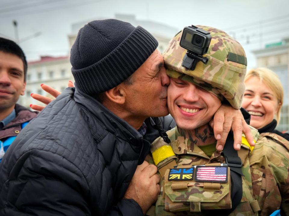 A Kherson resident kisses a Ukrainian soldier in central Kherson, Ukraine, Sunday, Nov. 13, 2022.