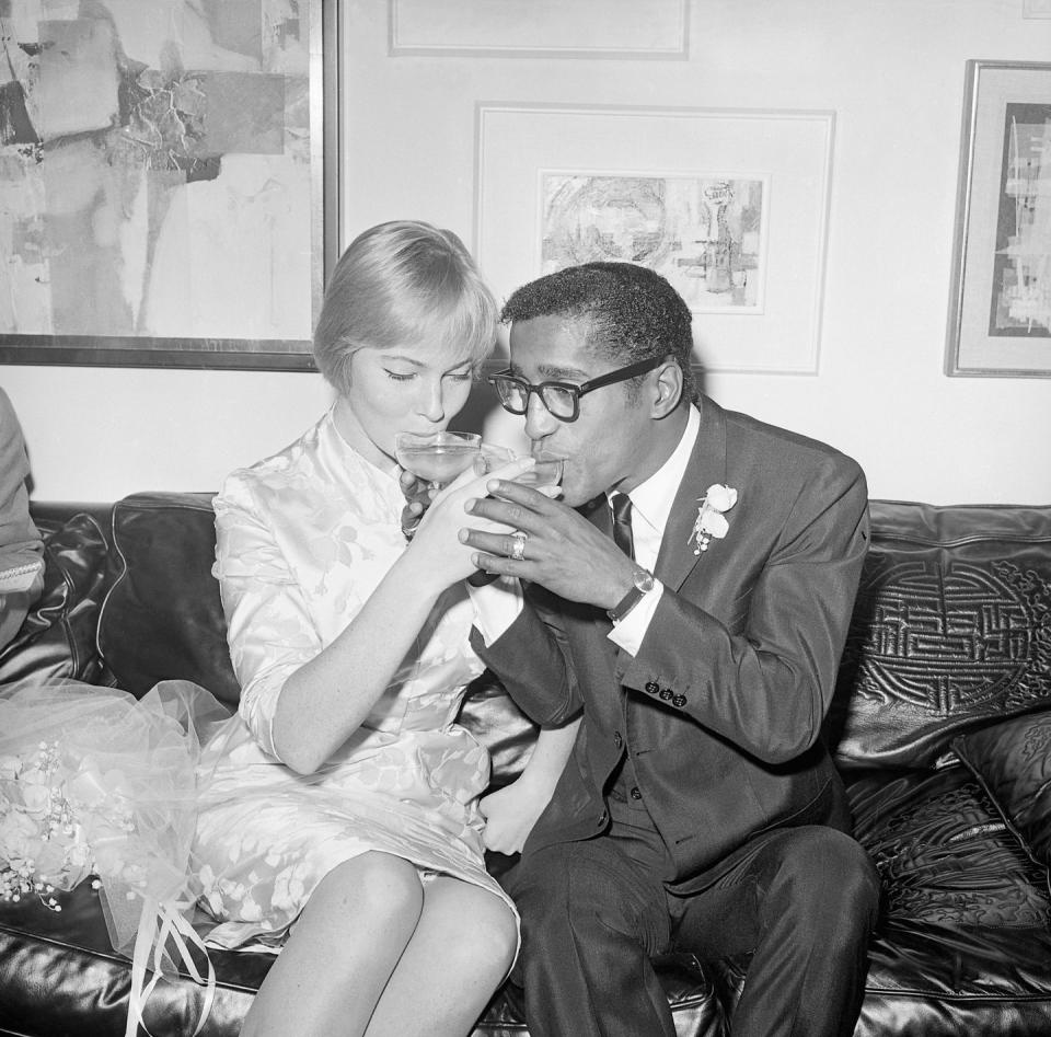 <p>May Britt and Sammy Davis Jr. share a champagne toast after becoming husband and wife in 1960. The couple opted for an intimate wedding ceremony followed by a reception at Davis's Hollywood home. <br></p>