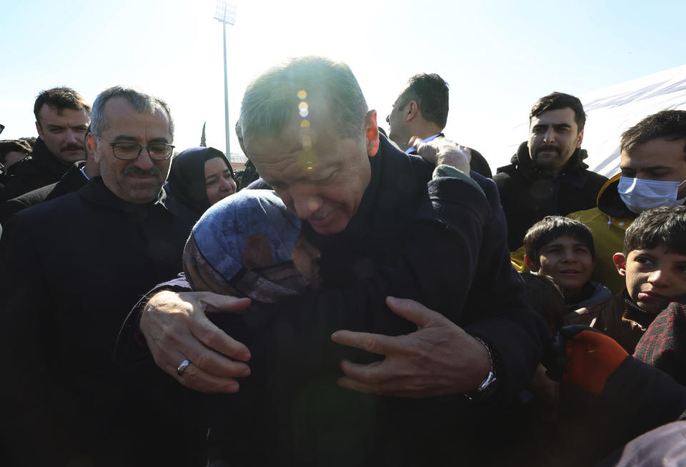 FILE - Turkey's President Recep Tayyip Erdogan and hugs a survivor as he visits the city center destroyed by the earthquake in Kahramanmaras, southern Turkey, on Feb. 8, 2023. Erdogan, who is seeking a third term in office as president in elections in May, marks 20 years in office on Tuesday, March 14, 2023. (Turkish Presidency via AP, File)