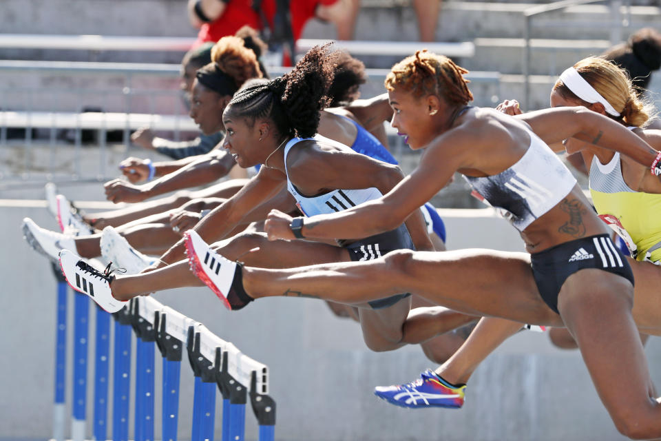 Keni Harrison, left, clears a hurdle ahead of fellow competitors during the women's 100-meter hurdles at the U.S. Championships athletics meet, Saturday, July 27, 2019, in Des Moines, Iowa. (AP Photo/Charlie Neibergall)