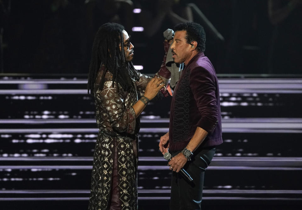 Lenny Kravitz, left, dabs inductee Lionel Richie with a cloth after his performance during the Rock & Roll Hall of Fame Induction Ceremony on Saturday, Nov. 5, 2022, at the Microsoft Theater in Los Angeles. (AP Photo/Chris Pizzello)