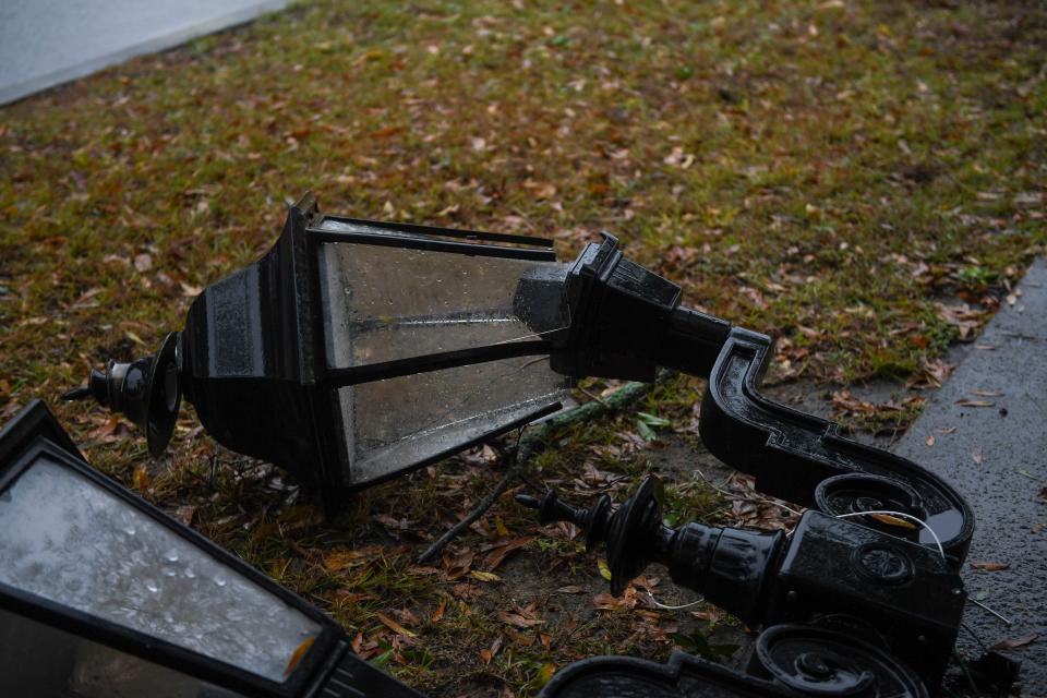 FILE - A lamp post lays on the sidewalk off Walton Way on Tuesday, Jan. 9, 2024. A large storm front moved through the area in the afternoon, bringing a severe thunderstorm warning and a tornado watch.