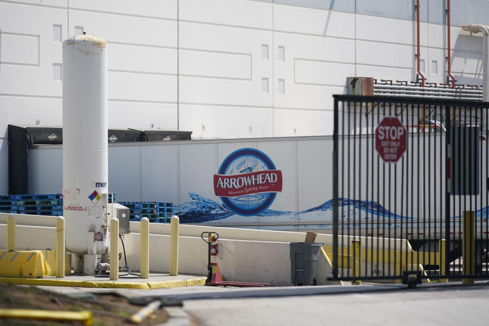 A truck is parked at a loading dock at a manufacturing facility for BlueTriton, the company that produces the widely-known Arrowhead brand of bottled water, Friday, Sept. 15, 2023, in Ontario, Calif. The State Water Resources Control Board is expected to vote Tuesday on whether to issue a cease-and-desist order against BlueTriton. The order would prevent the company from drawing water from certain points in the San Bernardino National Forest. (AP Photo/Ashley Landis)