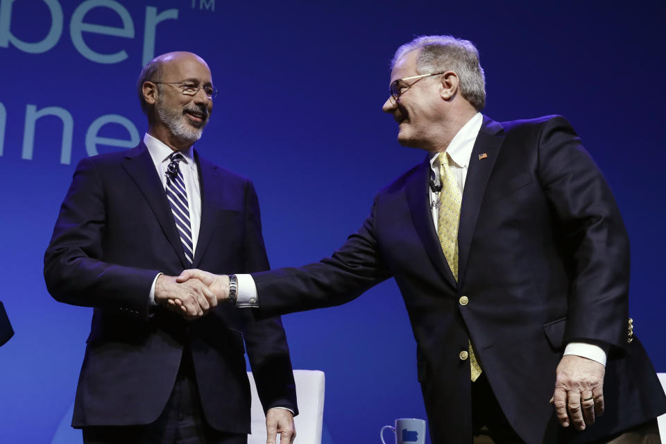 Democratic Gov. Tom Wolf, left, and Republican Scott Wagner shake hands at a gubernatorial debate in Hershey, Pa., Monday, Oct. 1, 2018. The debate is hosted by the Pennsylvania Chamber of Business and Industry. (AP Photo/Matt Rourke)